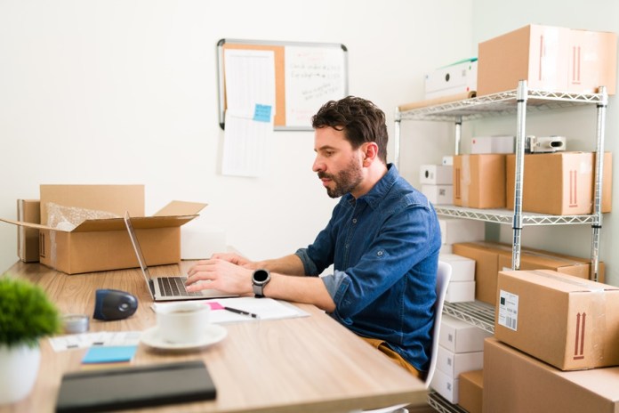 Business owner making a sales report at work