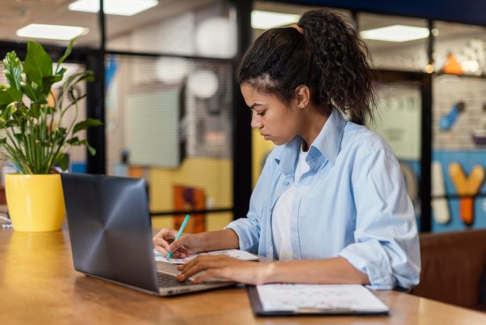 side-view-woman-office-working-with-laptop