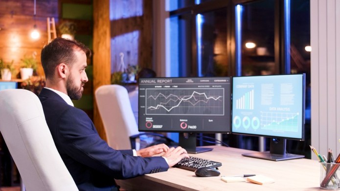 Business manager working on two screen setup