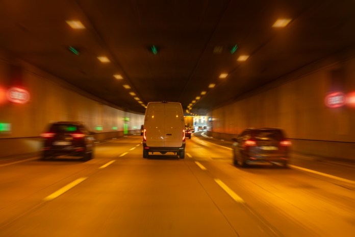 Van under smart lane control in tunnel. Regulated traffic flow.